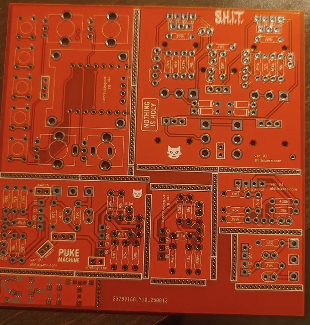 A red panel of circuit boards, the Puke Machine board at bottom left